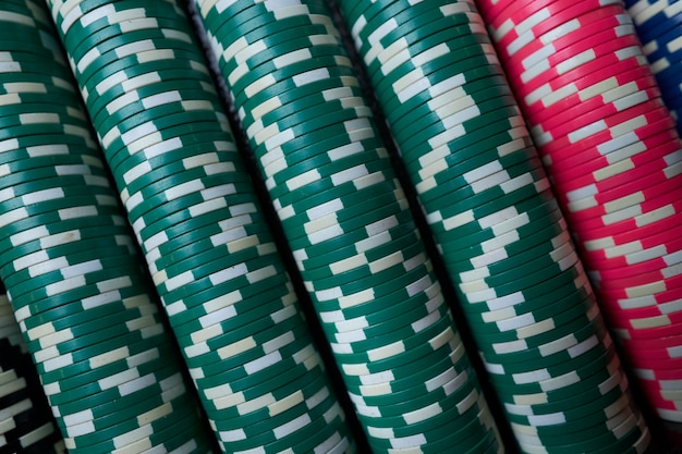 Poker chips colorful gaming pieces lie on the game table in the\
stack. background for online casino.