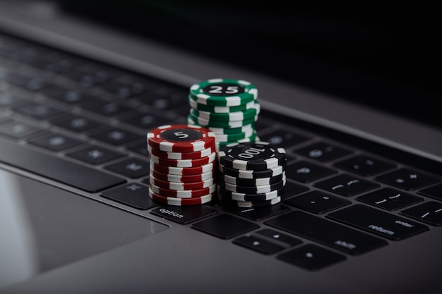 Poker chips on laptop. Casino online concept.