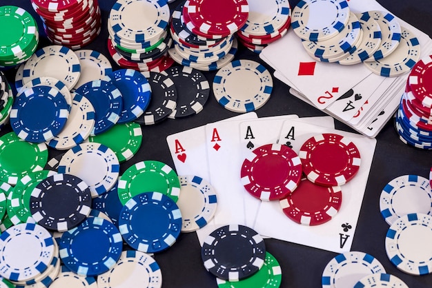 Poker chips mixed with cards on the table .