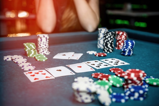 Poker chips and playing cards on table in casino