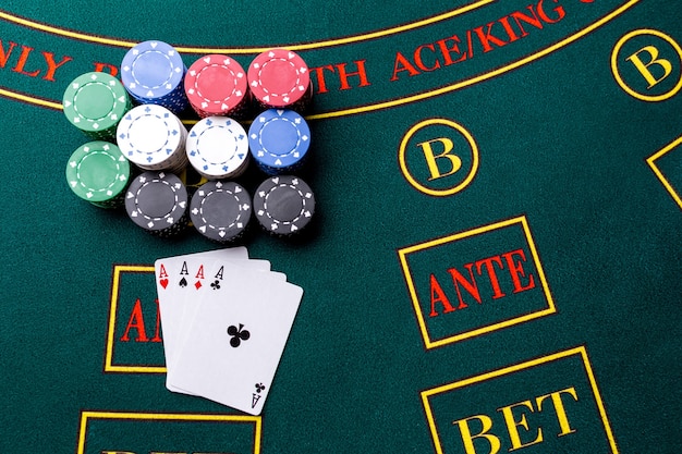 Poker chips on a poker table at the casino. Closeup. four aces, a winning combination. Chips winner