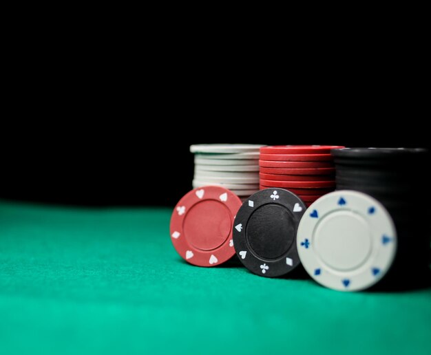 Photo poker game concept. casino concept or gambling. stack of poker chips on a green gaming poker table.