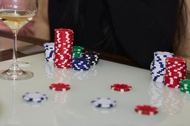 Poker game with dices and cards on the white table glasess of\
champagne candid moment