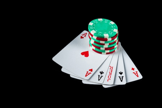 poker game with five of kind combination chips and cards on the black table