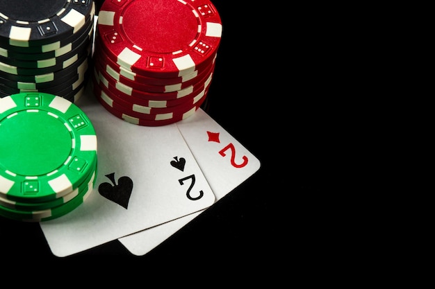 Poker game with one pair combination chips and cards on the\
black table in poker club