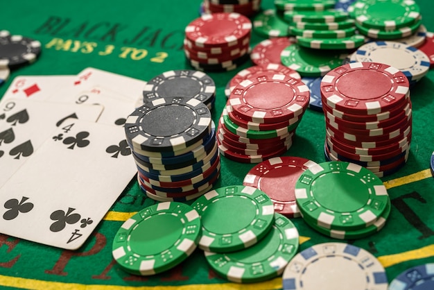 Poker play cards and chips on green table. Texas holdem