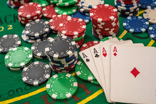 Poker play cards and chips on green table. Texas holdem