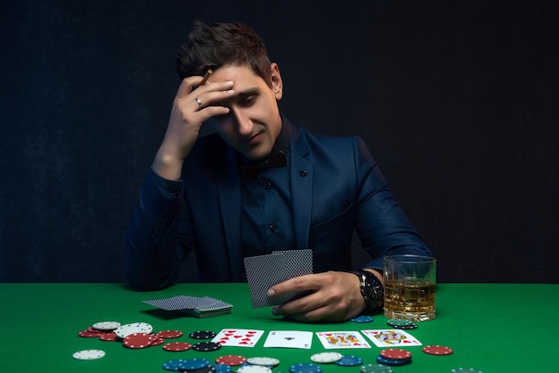 Poker player is frustrated and emotional over loosing and finding it hard to contain his emotions.