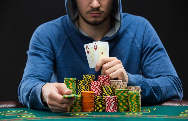 Poker player showing a pair of aces closeup