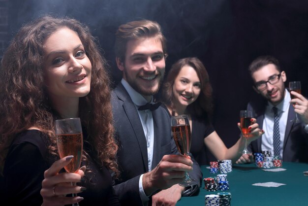 Poker players sitting at a table in a casino