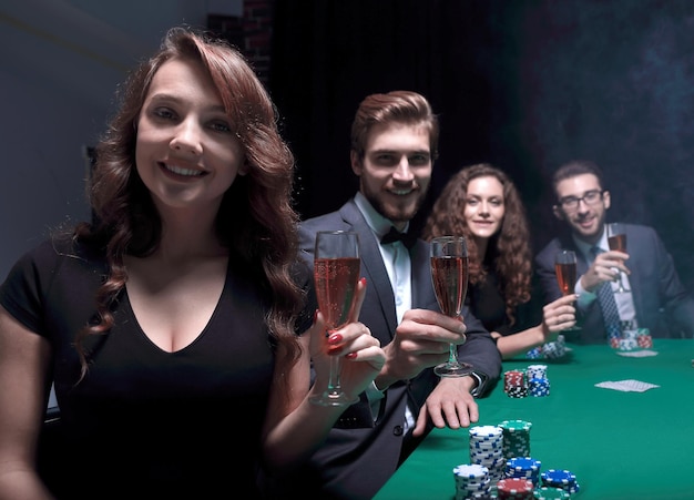 Poker players with a glass of winesitting at the table