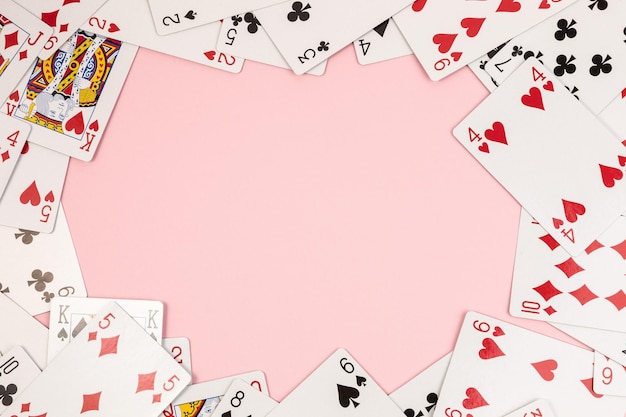 Poker playing cards on pink background