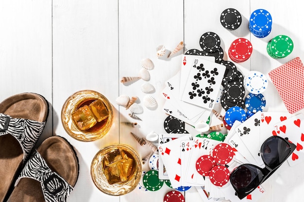 Poker. Set to playing poker with cards and chips on white wooden table, top view. Copy space