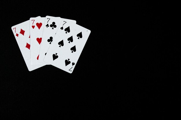 Poker of seven in black background