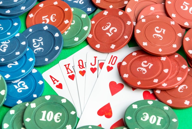 Pokerfiches met speelkaarten op de groene achtergrond