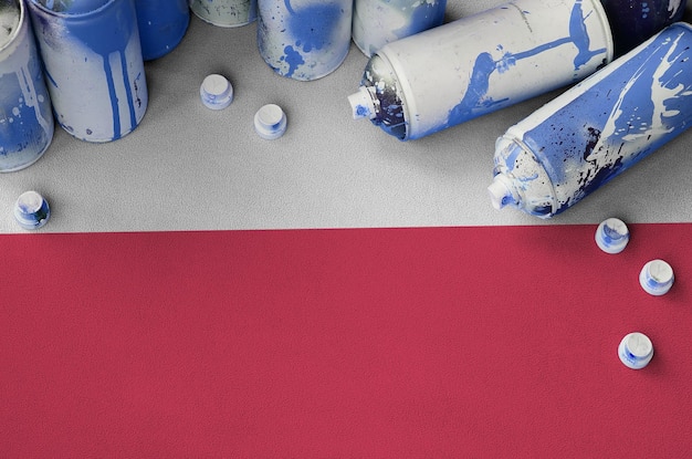 Poland flag and few used aerosol spray cans for graffiti painting street art culture concept