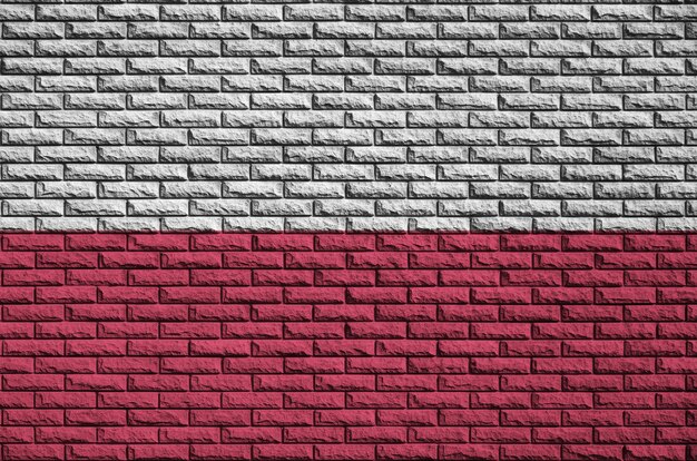 Poland flag is painted onto an old brick wall