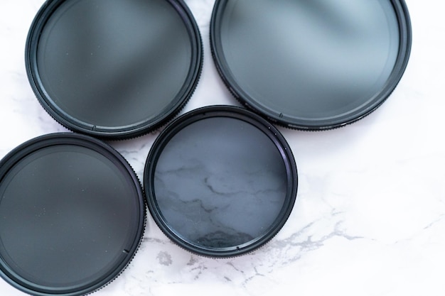 Polarized and neutral density filters on a white table.