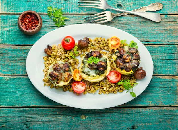 Polenta or corn porridge with mushrooms and spinach.Italian cuisine.