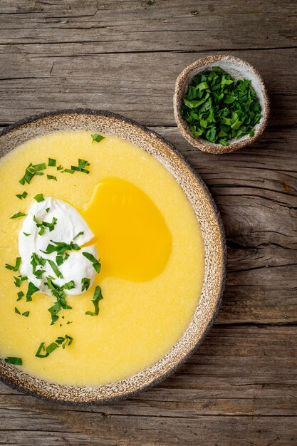 Photo polenta porridge with parmesan cheese and poached egg