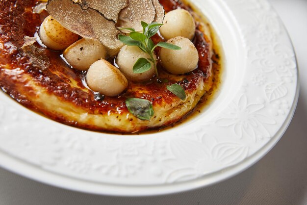 Polenta with cheese truffle pear balls on top oregano