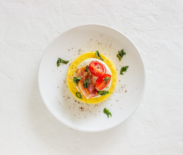 Polenta with mozzarella, bacon and tomatoes