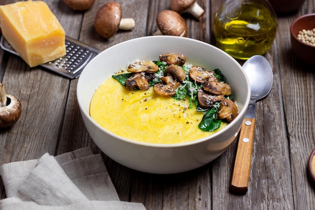 Polenta with mushrooms spinach and cheese Healthy eating Vegetarian food Italian cuisine