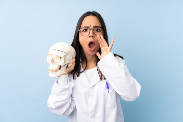 Police forensic specialist girl over isolated background shouting and announcing something