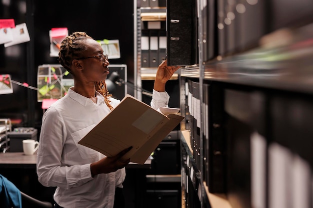 Photo police investigator studying archival crime case materials