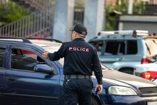 police man and street traffic in city