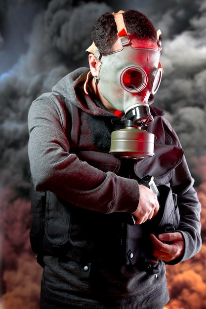 Police man with gas mask over explosion background