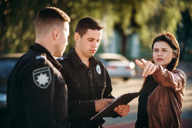 Photo policeman write testimony of female driver