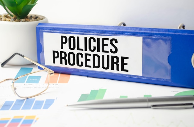 Policies and Procedure Two binders on desk in the office Business background