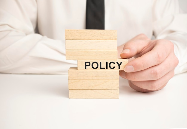 Policy word written on wood block Policy text on wooden table for your desing concept