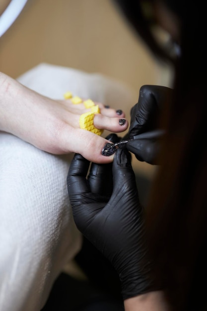 Polijsten nagels pedicure vrouwelijke benen in een schoonheidssalon pedicure nagellak