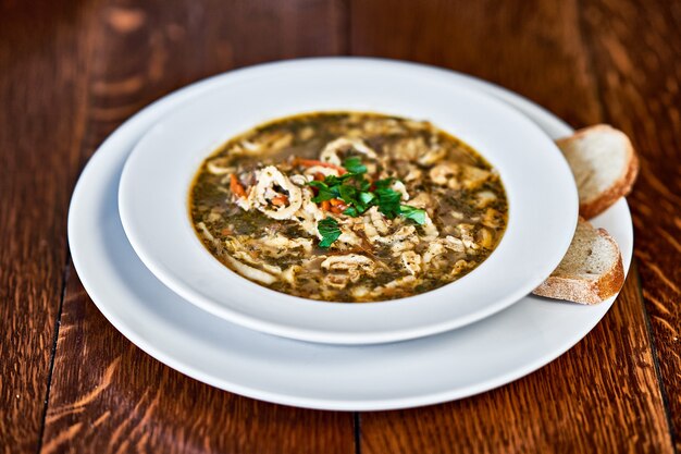 Polish beef tripe soup served on wooden table