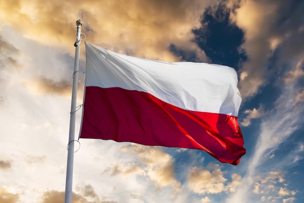 Polish flag waving against sunset sky