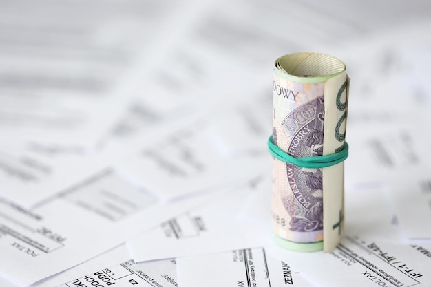 Photo polish zloty money pln on big amount of polish pit cit and vat tax forms close up accounting