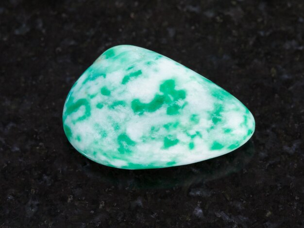 Photo polished amazonite gem stone on dark