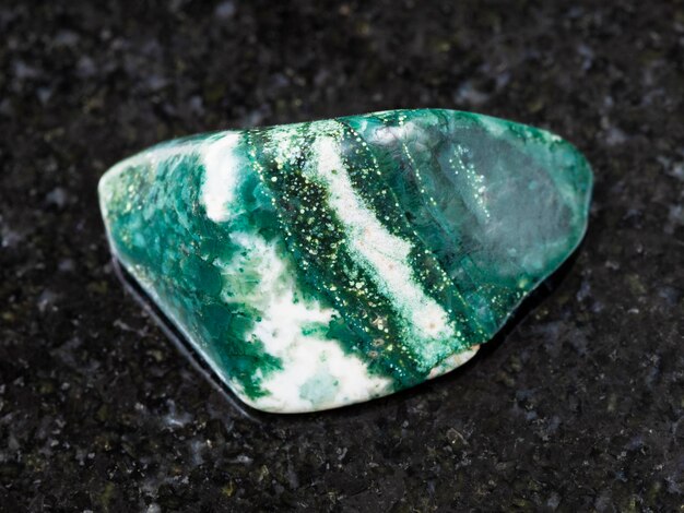 Polished Chlorite gemstone on dark background