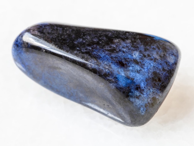 Polished dumortierite gem on white