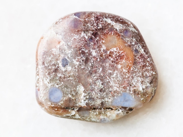 Polished porphyry gemstone on white