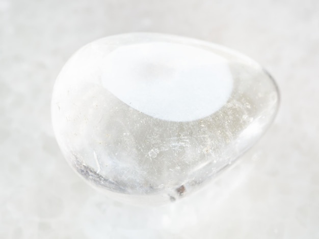 Polished Rockcrystal gemstone on white marble