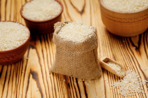 Polished round rice in bowls and bags on a wooden background High quality photo