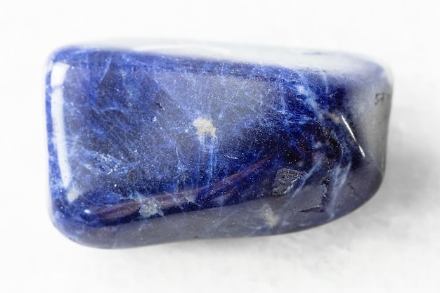 Polished Sodalite rock on white marble