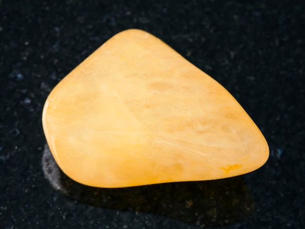 Polished yellow Aventurine gem stone on dark