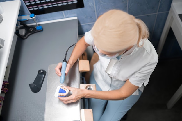 Polishing of dental prosthesis in office of dental technician