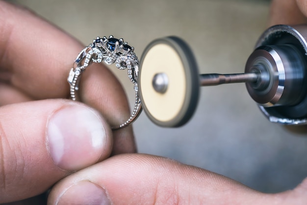 Photo polishing of the golden ring in a jewelry workshop