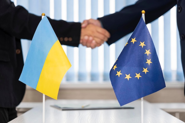 Political flags of ukraine and european union concept of\
negotiations collaboration and cooperation of countries agreement\
between the governments ukraine\'s accession to european union