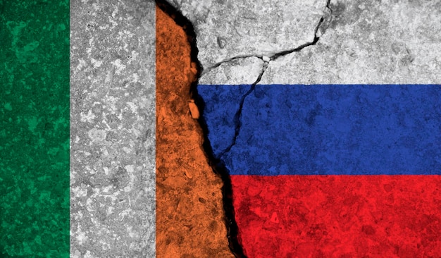 Political relationship between ireland and russia national flags on cracked concrete background